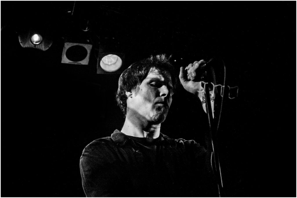Mark Lanegan at the Troubadour in 2007. An intimate show shot almost entirely in the dark except for one low-colored spotlight on him.