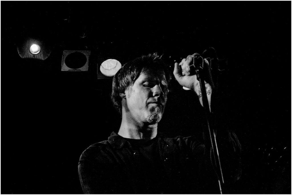 Mark Lanegan at the Troubadour in 2007. An intimate show shot almost entirely in the dark except for one low-colored spotlight on him.
